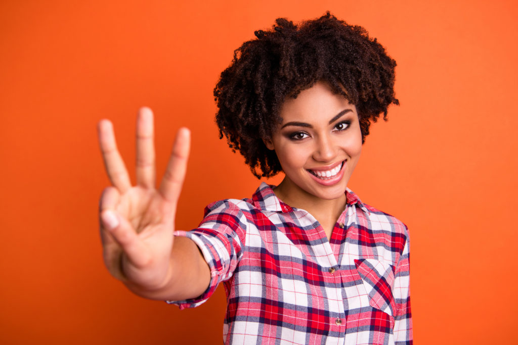 Smiling woman holding up three fingers when talking about the 3 things to look for in a window.